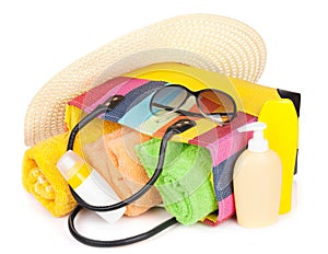 Bag with towels, sunglasses, hat and beach items