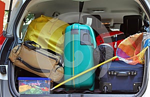 Bag and trolley with a fishing net in the trunk of the car