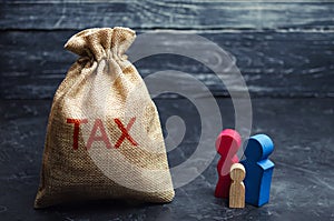 A bag with the word Tax and family. Taxes on real estate, payment. Penalty, arrears. Register of taxpayers for property. Law-