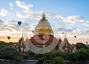 Bagan, Myanmar - Dhammayazika Pagoda with hot-air balloons.