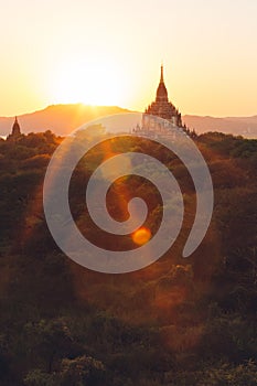 Bagan, Myanmar - FEB 21th 2014: Sunset landscape view with silhouettes of Buddhist monuments temple