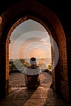 Bagan Myanmar, young woman watching Sunrise by an Budism temple pagoda at the historical site of Pagan photo