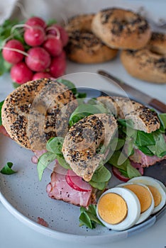 Bagel with cream cheese on wooden table