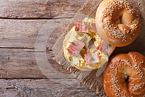 Bagel with egg and bacon close-up. horizontal view from above