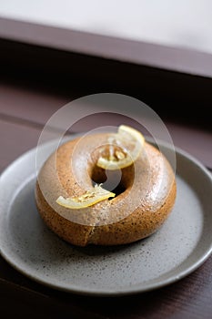 Bagel on the plate with a slice of lemon