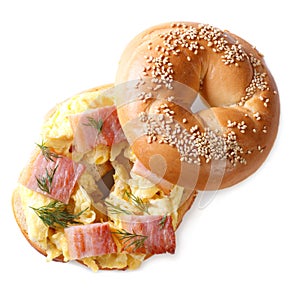 Bagel with scrambled eggs and bacon isolated on white