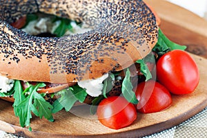 Bagels with arugula , fish and cream cheese