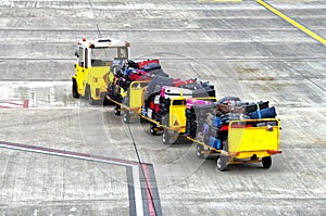 Baggage cars at an airport terminal. photo