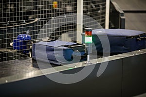 Baggage on a conveyor belt inside a luggage sorting system at an airport