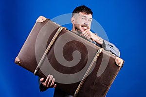 Baggage insurance. Man well groomed bearded hipster with big suitcase. Take all your things with you. Heavy suitcase