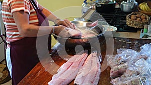 Bagging seasoned fish at mac's pizzeria on bequia