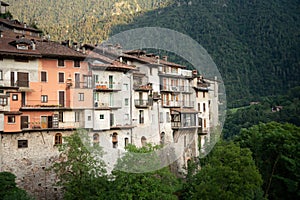 Bagolino medieval village. Old buildings and forested slopes.