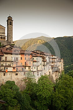 Bagolino medieval village. Old buildings and forested slopes.