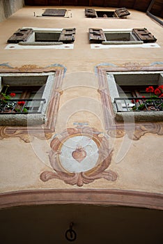 Bagolino medieval village, painted wall detail with religious frescoes.