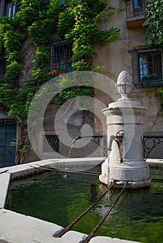 Bagolino medieval village, public water fountain in the central square