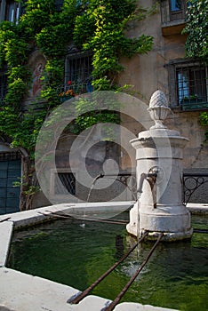 Bagolino medieval village, public water fountain in the central square photo