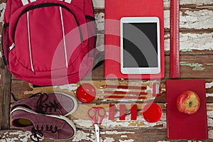 Bagpack, shoes, digital tablet, apple and stationary photo