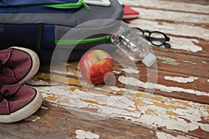 Bagpack, water bottle, apple, shoes and spectacle photo