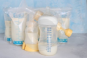 Bags with breast milk. Breast pump on yellow background. Milk bank. Expressing breast milk. Breast-feeding. Freezing and storing