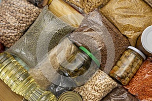 Bags of cereals and pasta, jars of marinades of vegetables, grains of cereals, porridge. Humanitarian aid with food, a grocery set