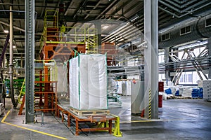 Bags with chemical production on conveyor at packing area at chemical factory