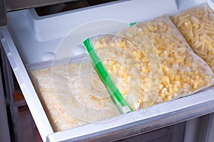 Bags with frozen vegetables in refrigerator