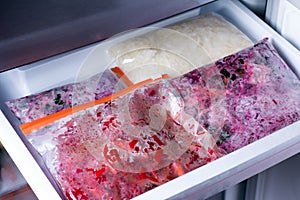 Bags with frozen vegetables in refrigerator