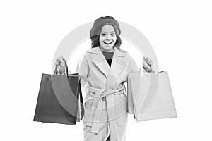 Bags are full. Happy shopper hold shopping bags. Little child smile with paper bags. Small girl enjoy seasonal sale