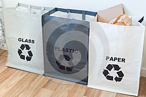 Bags for paper,  plastic, glass on kitchen, garbage sorting save earth concept