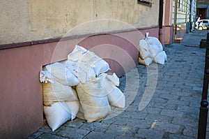 Bags with sand near shelter in old town Lviv, Ukraine. Defense from russian agression photo