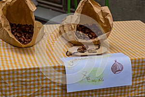 Bags of seasonal sweet chestnuts available for sale at a local Italian market
