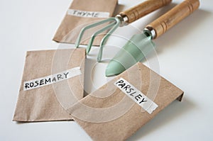 Bags with seeds of herbals, planting tools, gardening at home. Close up