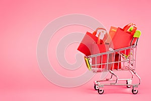 Bags in small trolley on pink