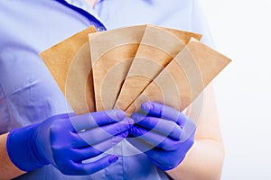 Bags for the sterilization of instruments in the hands clad in sterile gloves.