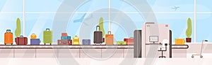 Bags, suitcases on baggage carousel against window with flying aircrafts on background. Device with conveyor belt