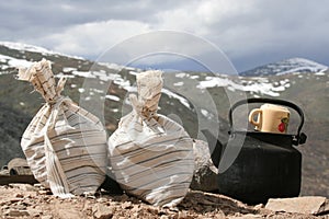 Bags with test of the mountain sorts and teapot photo