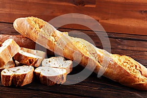 Baguette baked bread and sliced baguette on background