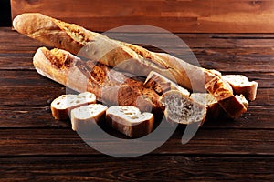 Baguette baked bread and sliced baguette on background