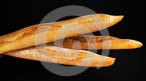 Baguette bread isolated on black background