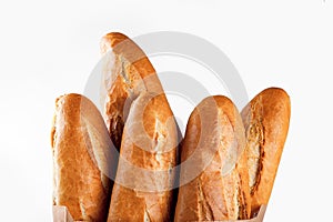 Baguette bread in paper bag on white background