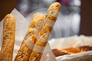 Baguette close up with pastry buffet on background