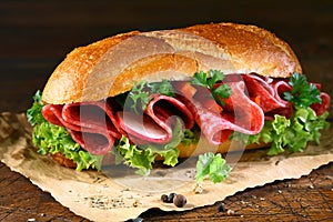 Baguette with fresh lettuce and salami