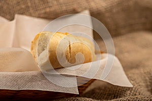Baguette with garlic paste cut into pieces, close-up, selective focus