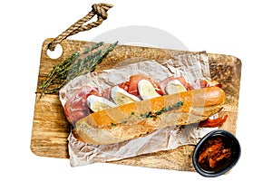 Baguette sandwich with prosciutto ham, Camembert cheese on a cutting Board Isolated on white background. Top view.