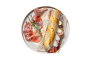 Baguette sandwich with prosciutto ham, Camembert cheese on a plate. Isolated on white background.