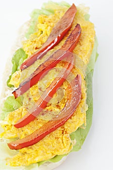 Baguette with scrambled eggs and pepper