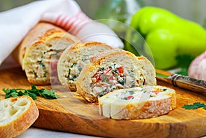 Baguette stuffed with a salad of baked chicken, cheese and fresh vegetables