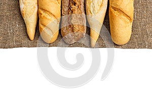 Baguette of whole wheat bread on a white background