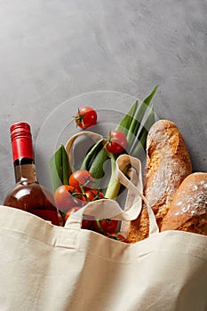 Baguettes, wine and groceries in a fabric bag