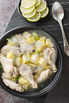 Bahamian chicken souse is a poultry dish made with chicken wings, onions, potatoes, celery, lime juice, allspice closeup on the